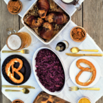 All-in-one guide for hosting your own Oktoberfest feast: roasted pork knuckle, sweet-tart red cabbage, cheesy noodle dumplings, & flaky apple strudel!