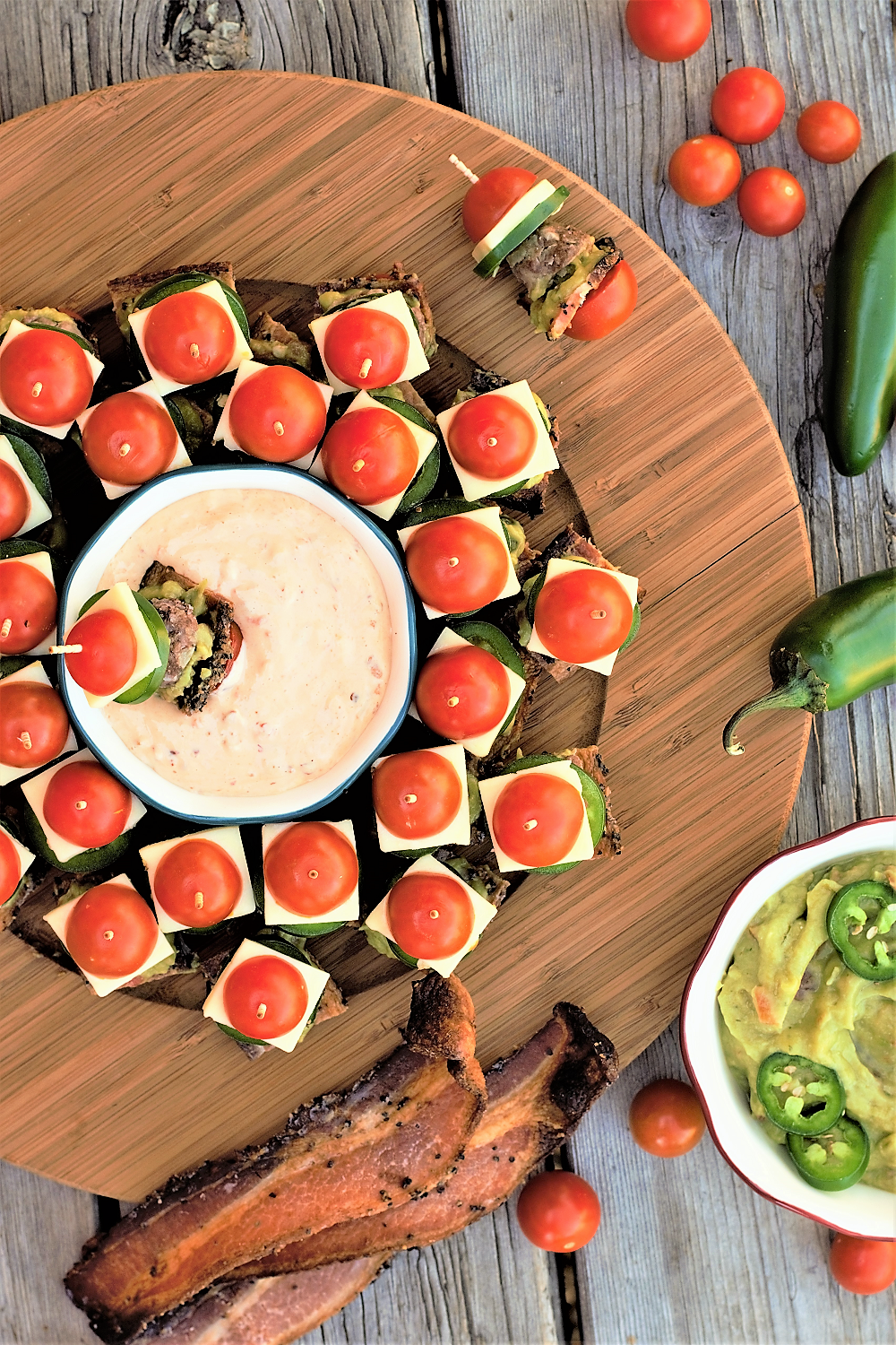 One giant delicious bite of meatballs, thick bacon, guacamole, jack cheese, & jalapeño slices skewered between cherry tomato 'buns' for the perfect healthyish party food!