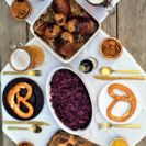 All-in-one guide for hosting your own Oktoberfest feast: roasted pork knuckle, sweet-tart red cabbage, cheesy noodle dumplings, & flaky apple strudel!