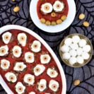 Kinda-gross, kinda-cute party appetizer couldn't be easier: mozzarella balls stuffed into meatballs, topped with olive 'eyes', & dished up on marinara.