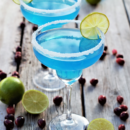 Gorgeous icy blue cocktails with rum, white cranberry, curacao, & lime rimmed with sparkling snowflake sugar to bring on the snow for a blue blue Christmas!